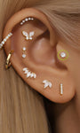 14K gold CZ ear piercings: butterfly, bar, marquise, round studs on ear.