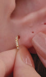 Edgy full ear stacking look with KOSINER Prism 14K solid gold geometric flat back studs, mix of spike dangle studs, chain rook piercing hoop, pave cz helix studs, modern sharp-line cartilage piercing styling for multiple ear placements