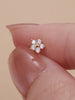 Ear stacking styling with KOSINER 14K solid gold five-petal flower cartilage studs, layered multi-position lobe helix ear jewelry look