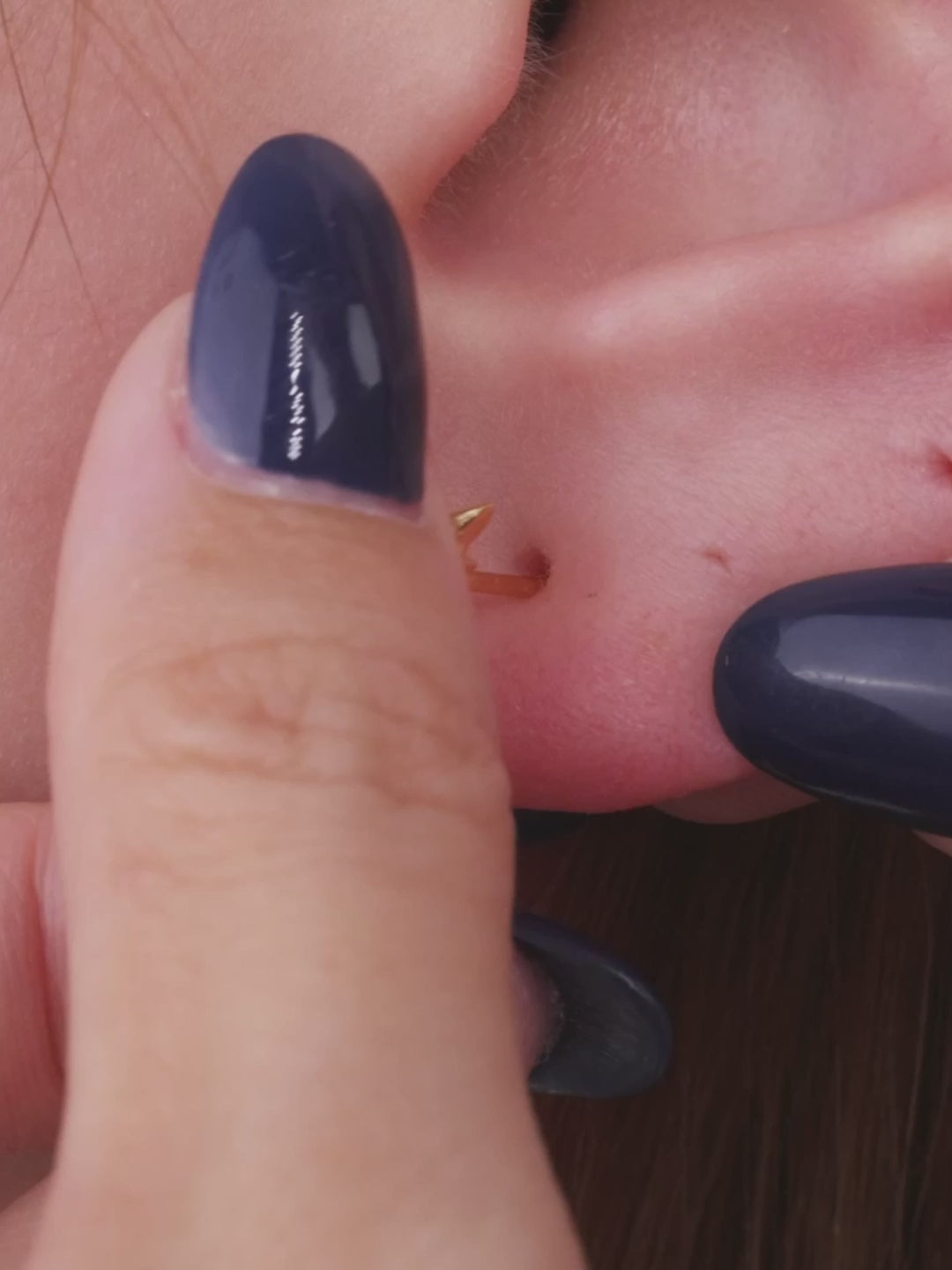 Close-up of KOSINER Rising Star gold-plated Shining Star stud styled with a star dangle hoop and matching studs