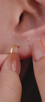 Trendy layered full ear stacking styling with KOSINER Prism baguette flat back stud, matched chain-dangle helix piercing, sunburst cz rook hoop, textured gold lobe hoops, minimalist geometric cartilage ear aesthetic for multi-position piercings