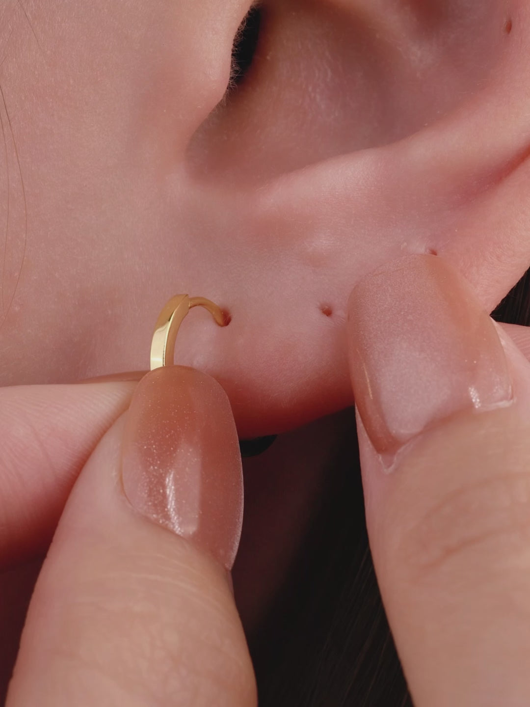 Edgy layered full ear stacking aesthetic with KOSINER Prism solitaire triangle spike flat back stud, matched dangling spike piercings, chain detail helix jewelry, sunburst rook hoop, modern sharp-line personalized ear piercing styling