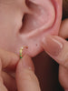 Layered full ear stack styling with KOSINER Gem Garden nature gem collection, peridot crown 14K gold flat back stud matched with aquamarine, multi-color teardrop and triangle gem cartilage piercings