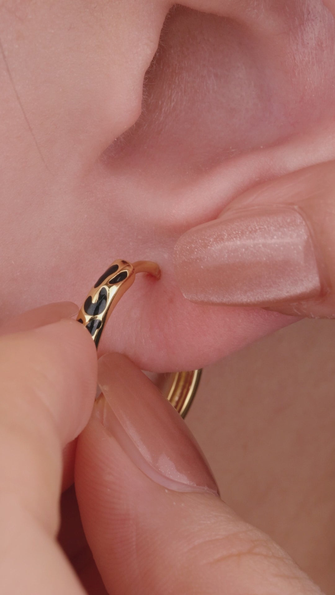 Trendy layered full ear stacking look featuring KOSINER Puzzle dual two-tone triangle flat back helix stud, matched figure-8 two-tone stud, two-tone pave hoop, tiny single cz cartilage studs, modern contrasting geometric multi-piercing ear styling