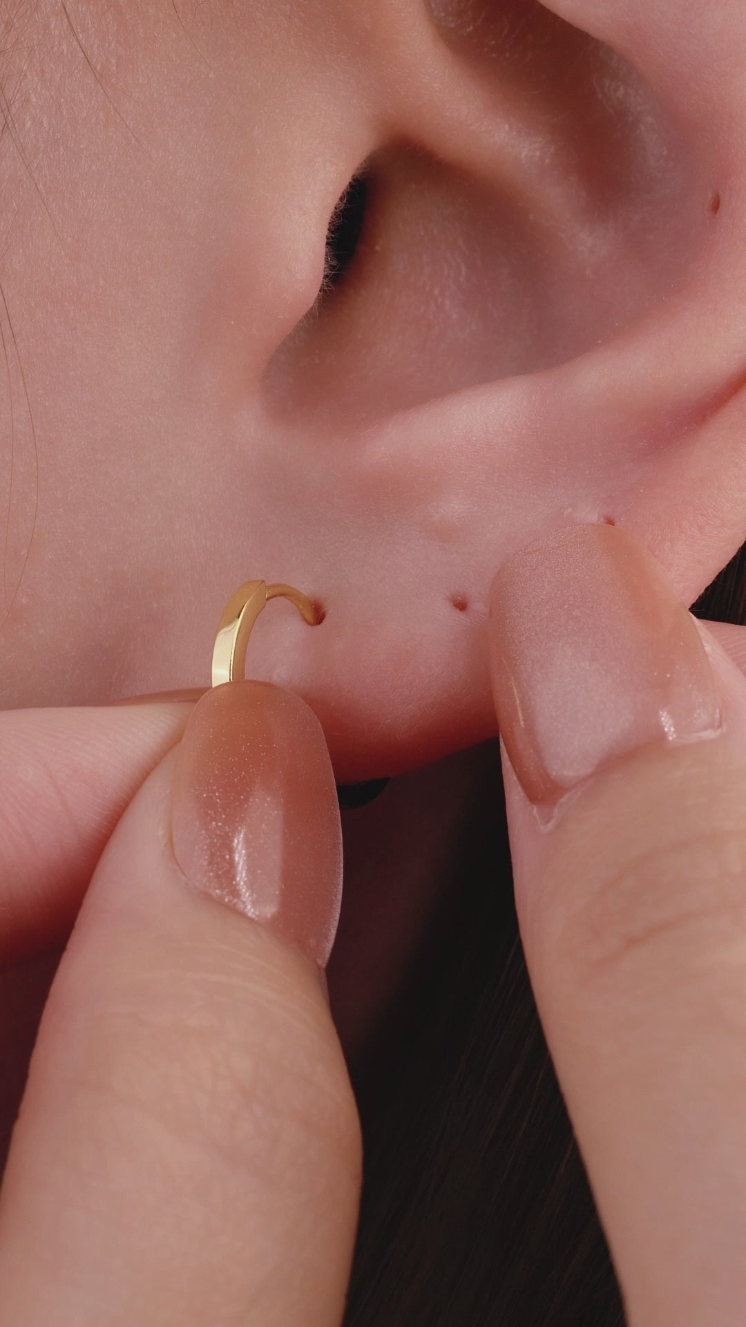 Trendy layered full ear stack styling with KOSINER gold cross drop hoop earring, paired sunburst cz rook hoop, chain dangle helix stud, baguette flat studs, textured bead hoop, minimalist edgy cartilage ear piercing stacking aesthetic