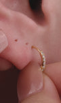 Elegant curated multi-piercing ear stack featuring KOSINER Starlight four-point star hoop fitted in daith piercing, styled with matching star studs, drop star hoop, pave stone hoop and assorted tiny cartilage studs, sophisticated layered ear styling design