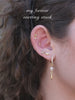 Model wearing KOSINER olive branch marquise drop flat back stud in a gold ear stack