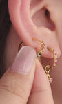Layered full ear stack with KOSINER Orchard fruit studs and rainbow ear climber, pineapple, banana, purple cherry flat cartilage piercings match rainbow curved crawler earring