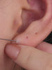 Side profile shot of KOSINER Seaspritz 14K solid gold ice cream internally threaded flat back stud, detailed cone texture and prong-set round cz stone, complete post structure showing 14K marking for premium piercing jewelry