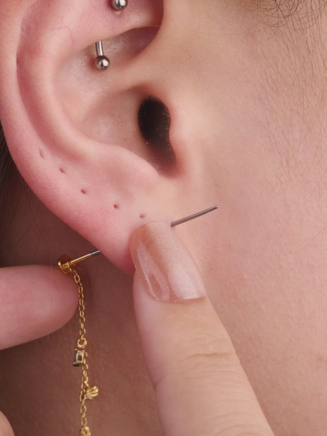 Model wearing KOSINER oceanic crab flatback stud in a curated ear stack