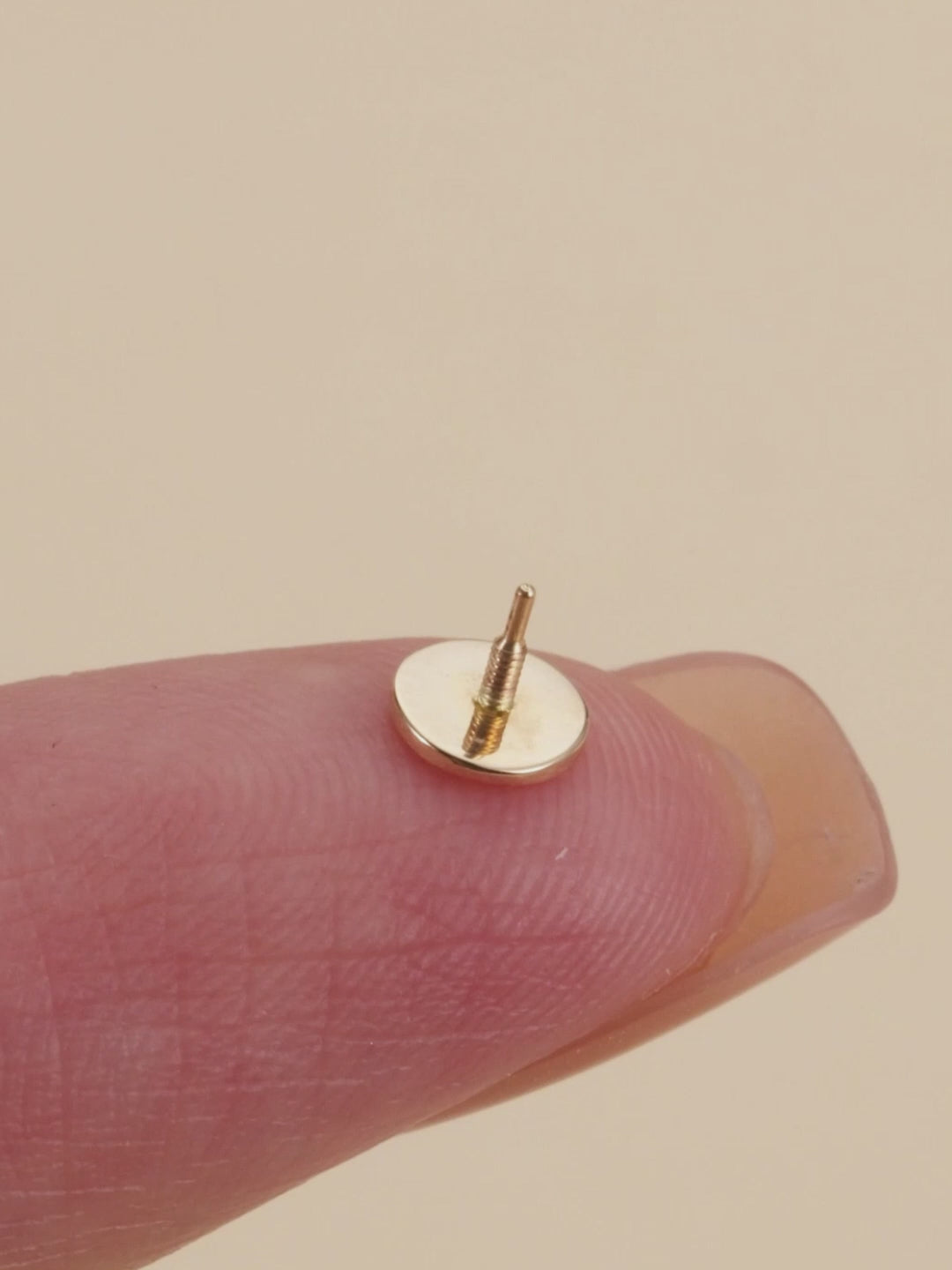 KOSINER 14K gold minimalist disc stud close-up, smooth polished finish