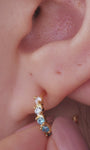 Layered ear stack styling with KOSINER aquamarine gem collection, marquise floral silver clicker hoop matched with ocean themed tiny cartilage piercings