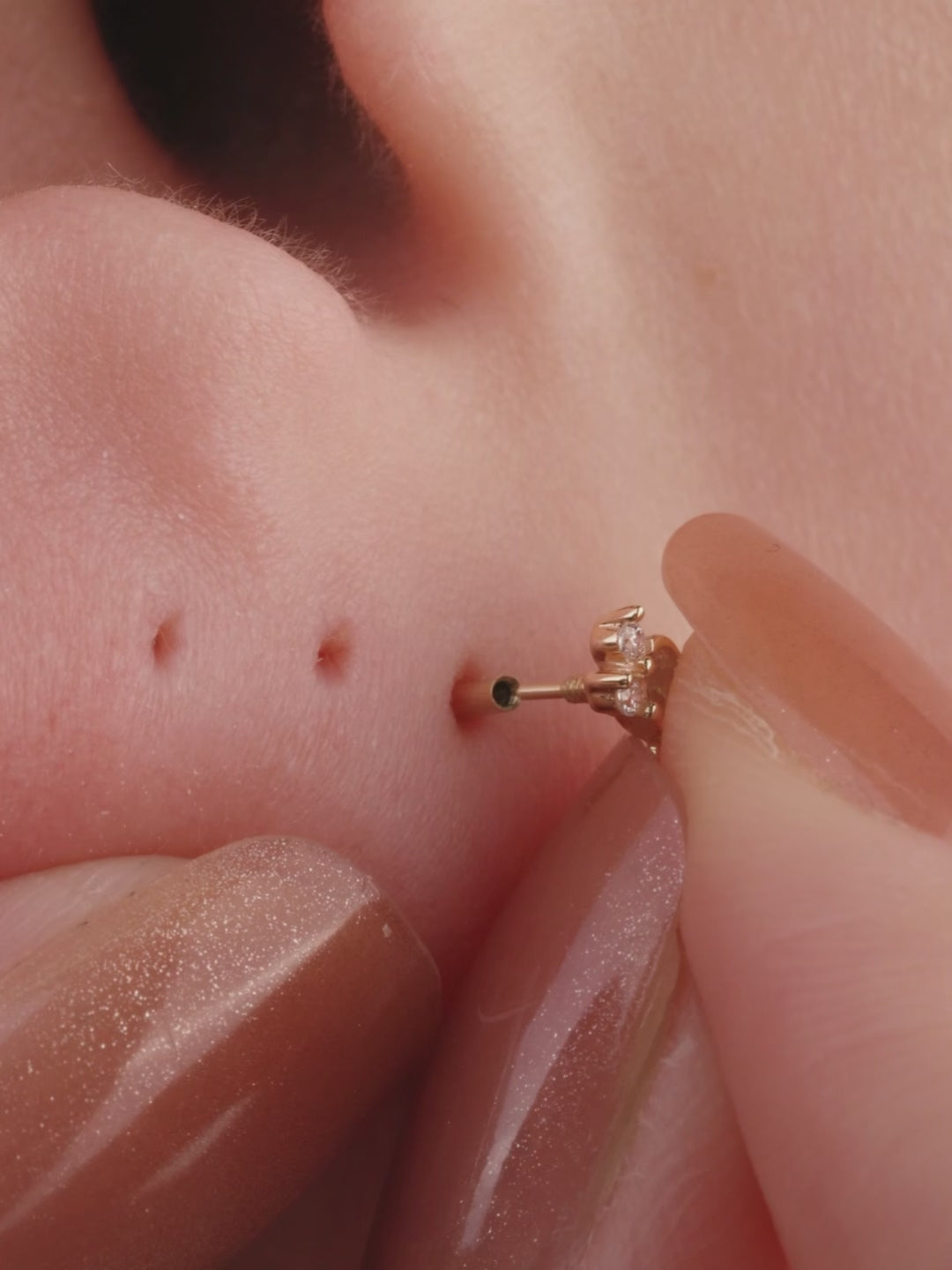 Ear stacking look with assorted KOSINER 14K solid gold flower cartilage piercing studs, multi-position helix lobe layered ear jewelry styling