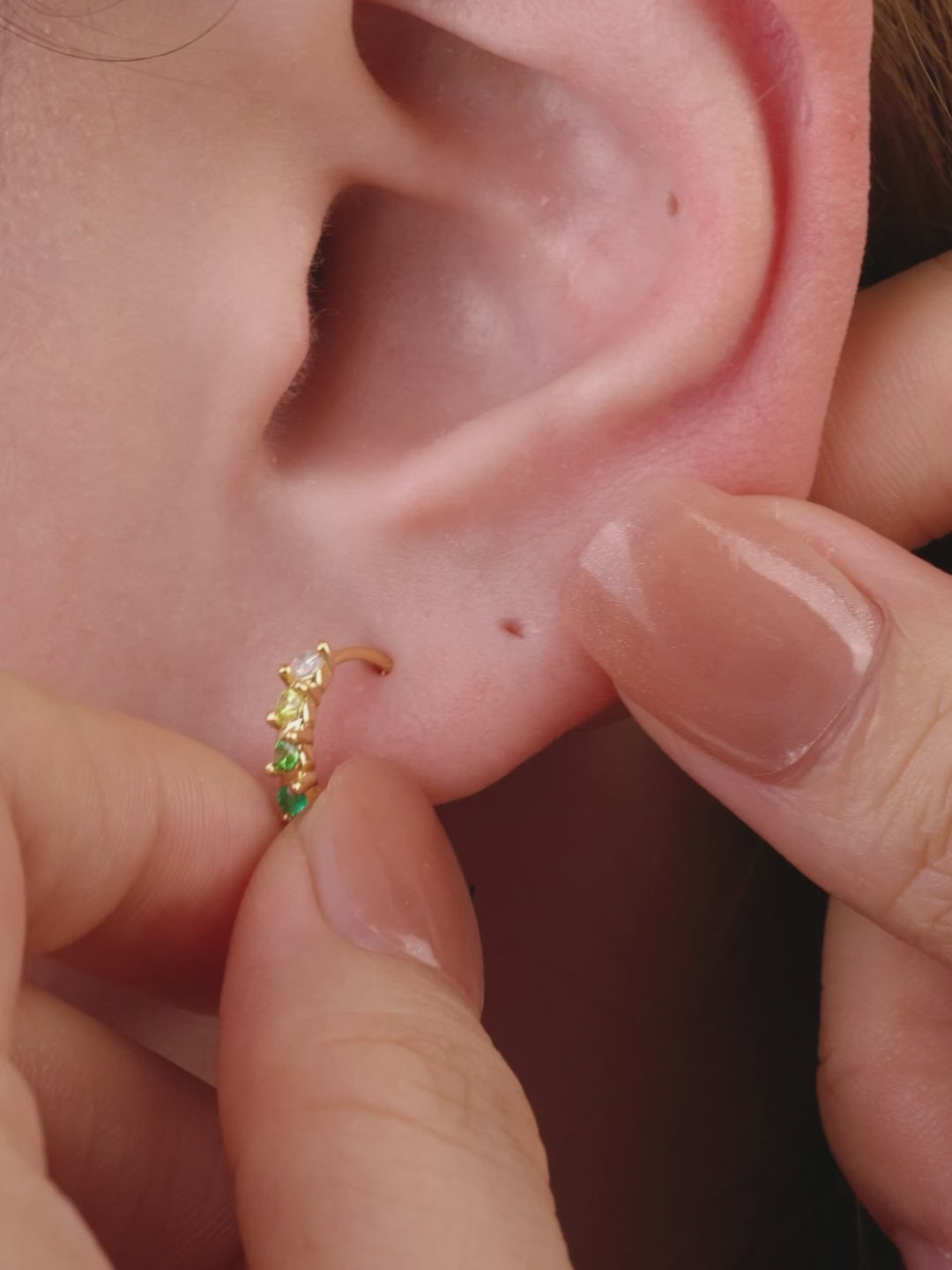 Layered full ear stack look with KOSINER Gem Garden natural gem collection, three-tone triangle 14K gold flat back stud matched with aquamarine, emerald and peridot tiny cartilage piercings