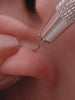 Stylish curated multi-piercing ear stack featuring poker suit themed studs (club, spade, four-petal flower, star) plus chain linked ear cuff and textured huggie hoop, versatile layering design for helix, conch and lobe piercings