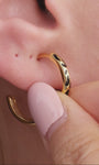 Elegant layered full ear stacking styling with KOSINER Puzzle two-tone black white pave cz sterling silver hoop earring, matched tiny cz cartilage studs, geometric two-tone triangle studs, plain gold huggie hoop, contemporary contrasting detail everyday ear look