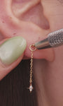 Model curated multi piercing ear styling, 14k gold long chain marquise star detachable dangle charm on gold hoop earring, layered celestial ear jewellery